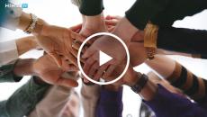 Group of people putting their hands together Group of people putting their hands together
