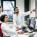 Healthcare workers pointing at a medical image on a display