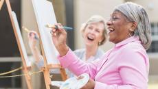 Laughing people painting
