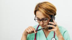 Clinician talking on phone to a patient screening for SDOH
