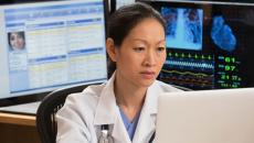 A doctor working on a laptop