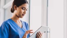A clinician enters documentation on a tablet.