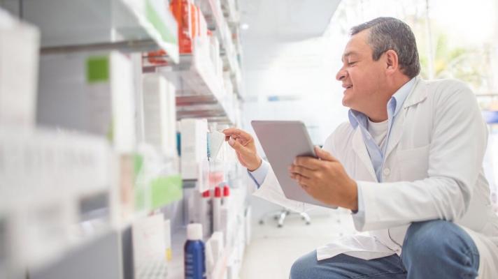 A pharmacist doing an inventory using a digital tablet 